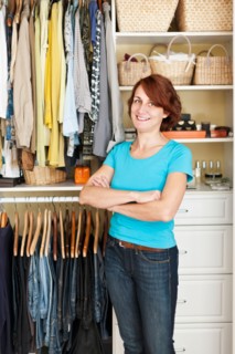 Portrait of woman in front of organized wardrobe. Photo :  Elena Elisseeva