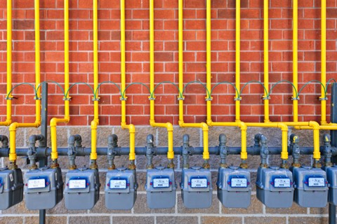 Gas meters against brick wall. Photo :  Elena Elisseeva
