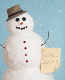 Studio shot of snowman dressed as fisherman.