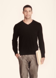Studio portrait of man holding folders.