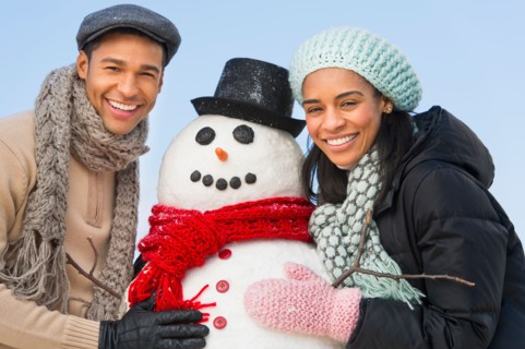 Portrait of couple with snowman.