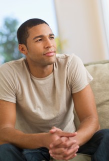 Portrait of man sitting on sofa.