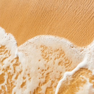 Mexico, Yucatan. Sea waves on beach sand.