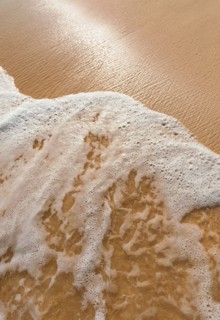Mexico, Yucatan. Sea waves on beach sand.