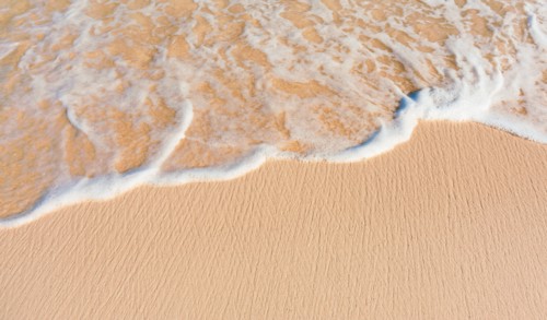 Mexico, Yucatan. Sea waves on beach sand.
