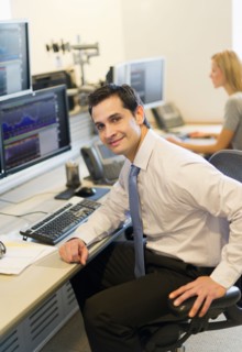 Portrait of trader at trading desk.