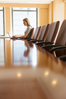 Businesswoman sitting in board room.