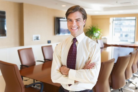 Portrait of businessman in board room.