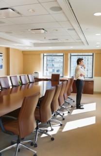 Businessman standing in board room.