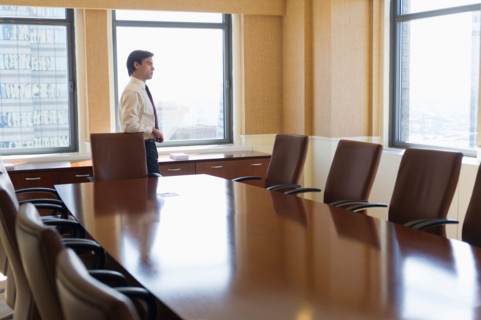 Businessman standing in board room.