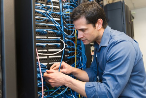 Technician inspecting network server.