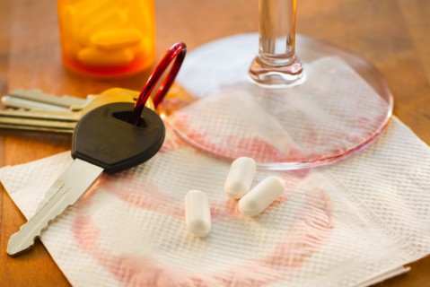 Car keys, pills and alcohol, studio shot.