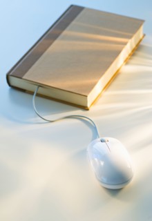 Studio shot of book with computer mouse.