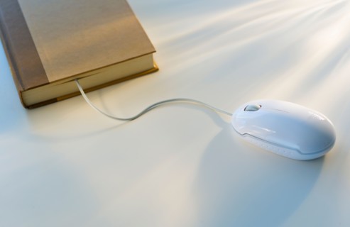Studio shot of book with computer mouse.