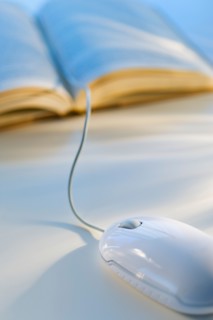 Studio shot of book with computer mouse.