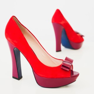 Pair of red high heel open toe shoes on white background.