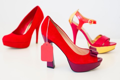 Red high heel shoes with price tag.