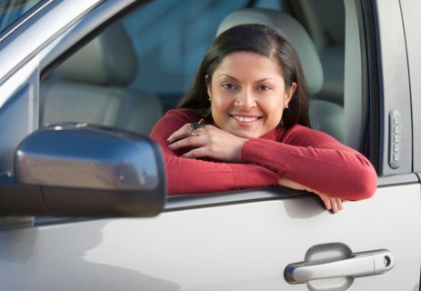 Woman sitting in her new car.