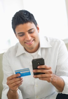 Man holding credit card and smart phone.