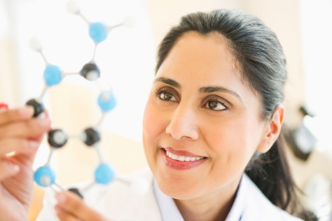 Scientist holding molecular model.
