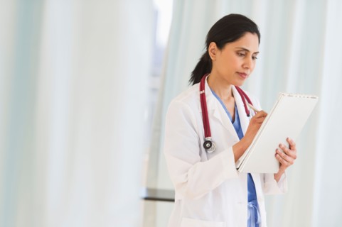 Doctor filling medical document.
