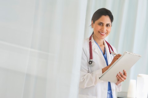 Doctor filling medical document.