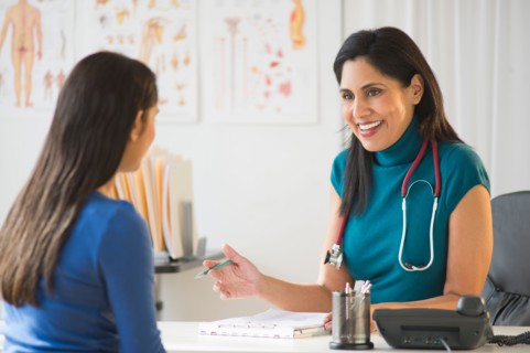 Doctor and patient  (12-13) in doctor's office.