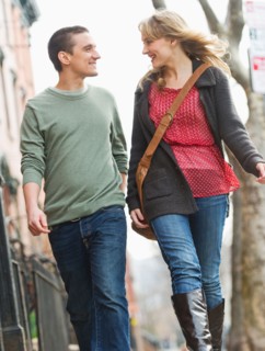 Couple walking on street.