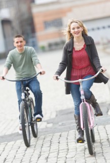 Couple cycling on street.