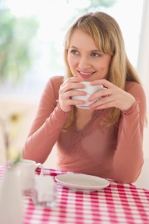 Portrait of woman sitting at table.