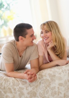Couple lying on bed .