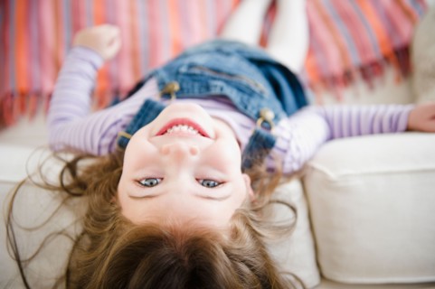 Small girl  (4-5 years) lying on sofa. Photo : Jamie Grill