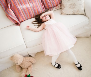 Small girl  (4-5 years)  in tulle dress leaning on sofa. Photo : Jamie Grill