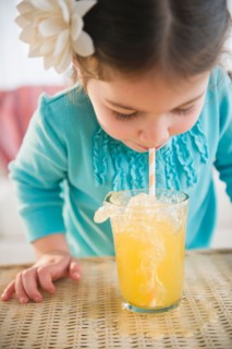 Small girl  (4-5 years) drinking juice with straw. Photo : Jamie Grill