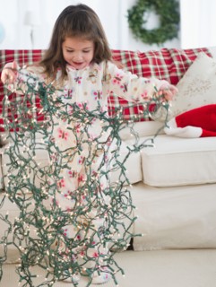 Small girl  (4-5 years) preparing Christmas lights. Photo : Jamie Grill