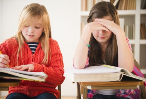 Two girls learning in classroom. Photo : Jamie Grill