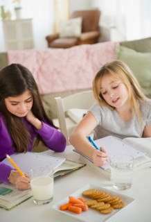 Two girls doing homework. Photo : Jamie Grill