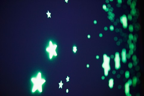 Close up of fluorescent stars on blue background, studio shot. Photo : Jamie Grill