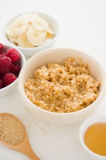 Close up of oats and fruits in bowls, studio shot. Photo : Jamie Grill