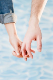 Close up of hands of couple, studio shot. Photo : Jamie Grill