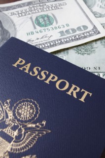 Close-up of passport and dollar banknotes. Photo : Winslow Productions