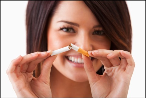 Young woman breaking cigarette. Photo : Mike Kemp