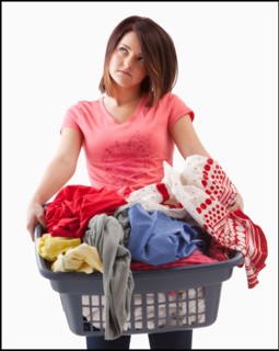Young woman with laundry basket. Photo : Mike Kemp