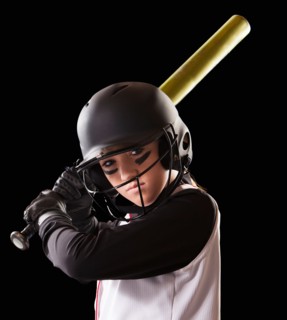 Portrait of girl (12-13) plying softball. Photo : Mike Kemp