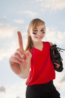 Portrait of girl (12-13) plying softball. Photo : Mike Kemp