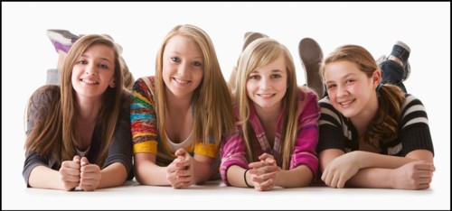 Studio shot of four happy girls (12-13). Photo : Mike Kemp