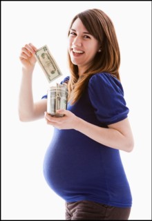 Studio Shot of woman holing baby jar with money. Photo : Mike Kemp