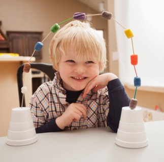 Boy (4-5) with his craft work. Photo : Mike Kemp