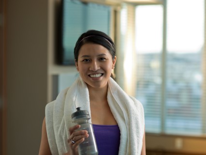 Portrait of Young woman exercising at home. Photo : Dan Bannister