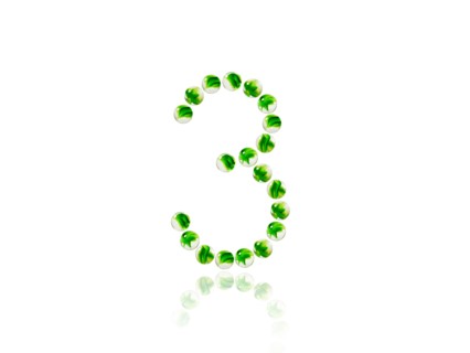 Studio shot of green marbles arranged in Exclamation Point. Photo : David Arky